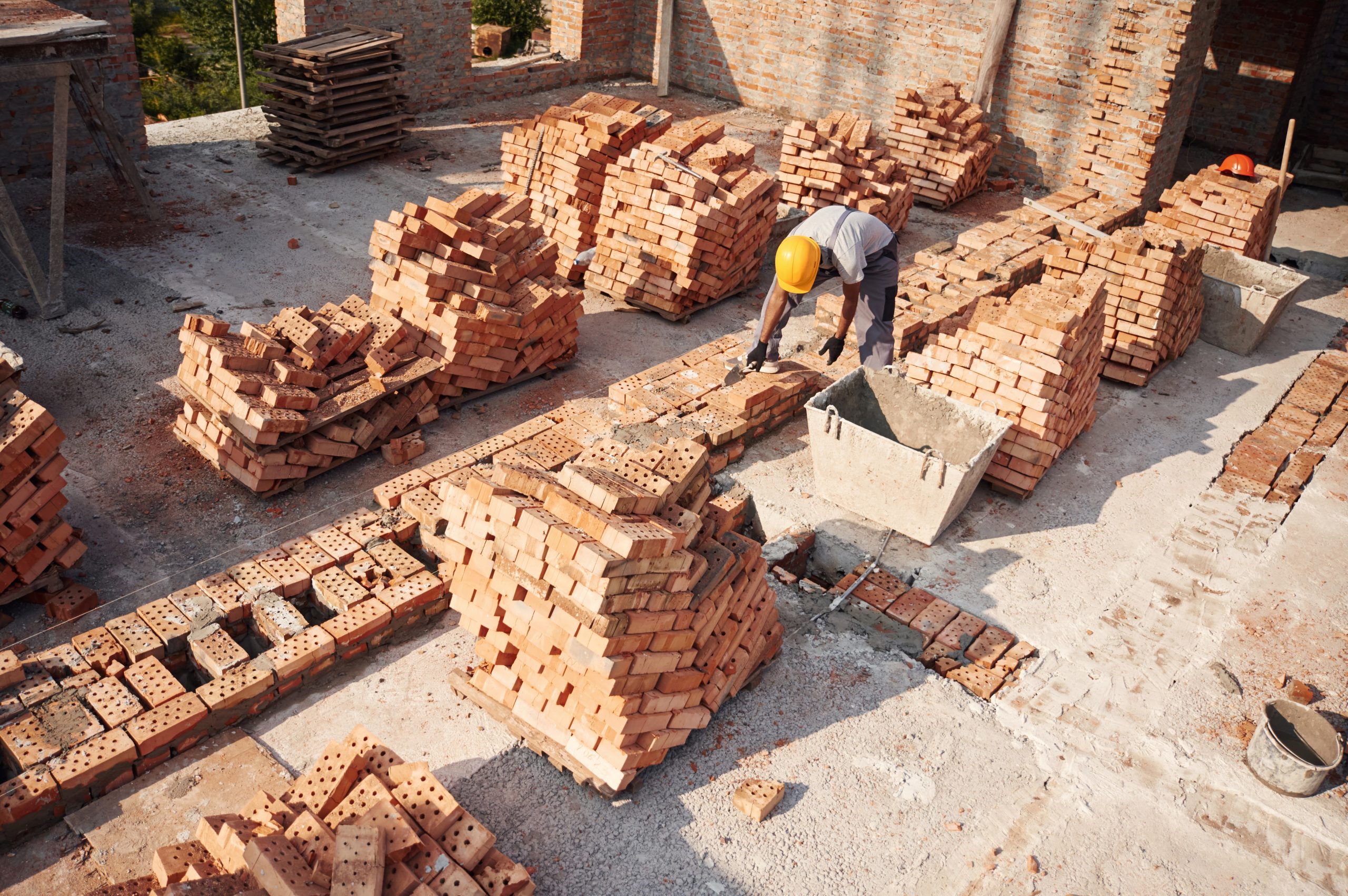 Top view. Handsome Indian man is on the construction site.